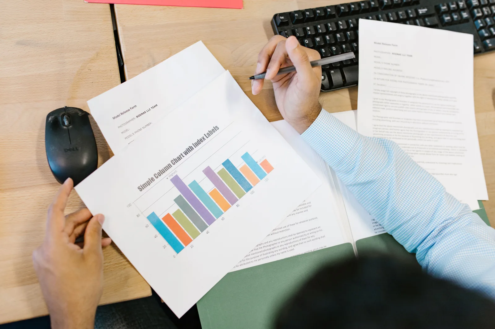 A business analyst reviews a colorful bar chart and documents at a desk, indicating data analysis. Creator career paths metrics: what to track
